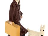 figurine of a man with a suitcase and a dog