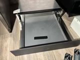 an open drawer with a key in it on the floor