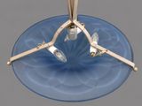 an image of a blue glass table with a metal base