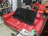 a red couch with a laptop on it in a room