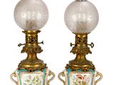 pair of antique lamps with floral designs on them on a white background