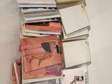 a lot of books that are stacked on top of each other