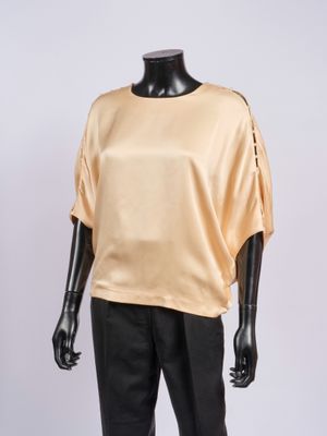 an image of a mannequin mannequin wearing a gold top and black pants