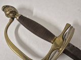 a sword that is laying on a white surface
