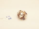 a gold ring with a diamond on it on a piece of paper