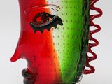 a glass vase with a red, green, and red design on it