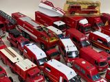 a lot of toy firetrucks that are on the table