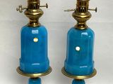 pair of blue glass lamps with brass fittings on stands