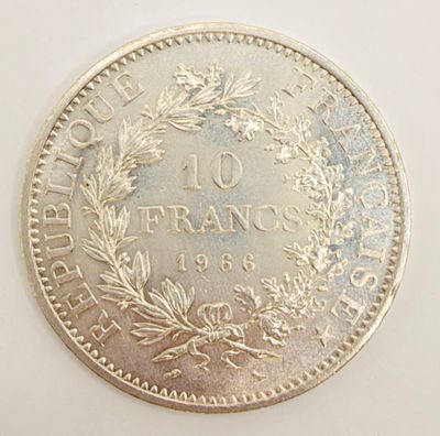 an old french 10 franc coin on a white surface