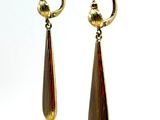 pair of gold tone earrings hanging from a gold plated hook