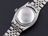 an image of a close up of a watch on a black surface