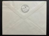 an envelope with a stamp on it sitting on top of a table