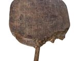 an old wooden stool with a wooden handle on a white background