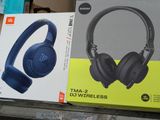 two boxes of headphones sitting on a shelf