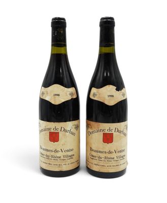 two bottles of wine sitting next to each other on a white surface