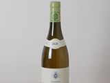 une bouteille de vin blanc posée sur une table en bois