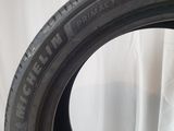 a close up of a tire on a table with a white background