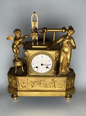 a gold clock with a statue on top of it