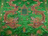 an image of a green cloth with a dragon design on it