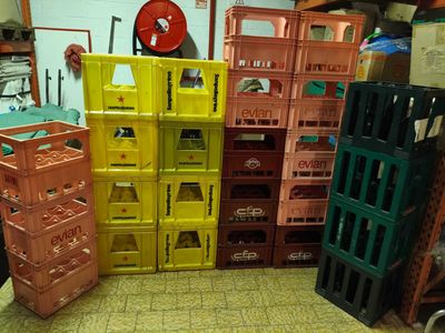many crates that are stacked on the floor in the room