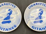 two blue and white plates with the words cigarettes and cigarettes on them