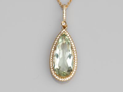 a green amethe and diamond pendant on a gold chain