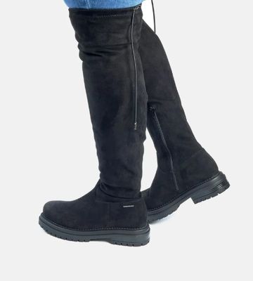 a close up view of a woman ' s legs wearing knee high boots