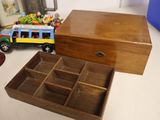 a small wooden box with a toy bus inside of it