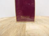 a picture of a box of perfume on a wooden table