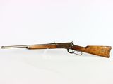 a rifle with a wooden barrel on a white background