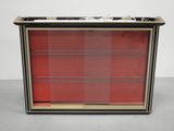 a black and red display case with red glass doors