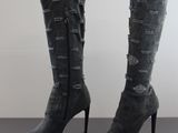 a close up of a pair of high heeled boots on a table