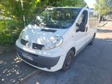 a small white van parked on the side of the road