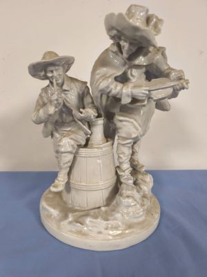 figurine of two men with guns and barrels on a blue table