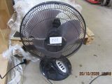 a fan that is sitting on the floor in a room