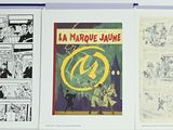 several pages of comics are spread out on a table