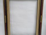picture frame with red, black, and gold inlays on a white background