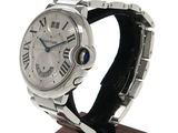 a watch that is on a wooden stand on a white background