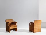 a pair of rattan chairs in the style of person