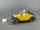 a yellow toy car with a man sitting in it