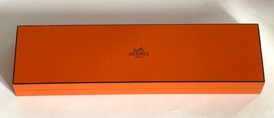 a close up of an orange box on a white surface