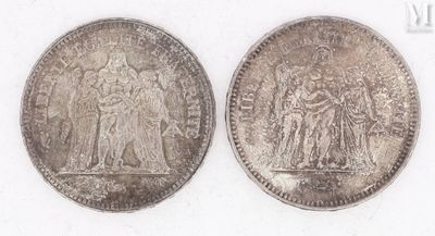 two silver coins, one of which is a woman and one of which is a man