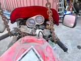 a close up of a motorcycle with a chain around the handlebars