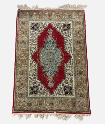 a red and blue rug with a medallion design on a white background