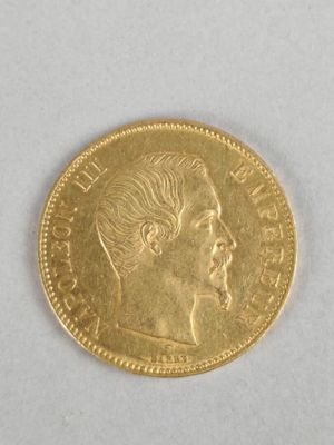 a close up of a gold coin on a white surface