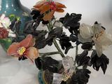 a vase that has flowers in it on a table