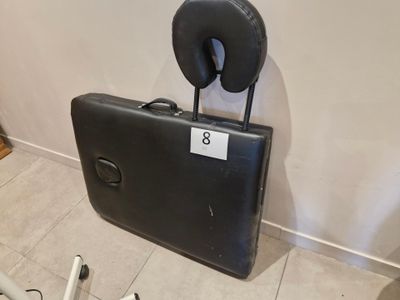 a piece of luggage sitting on the floor next to a bike
