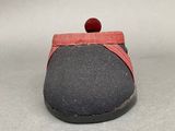 grey and red slippers with a red pom pom on top