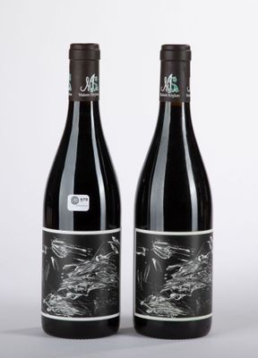 deux bouteilles de vin rouge posées l'une à côté de l'autre sur une table