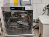 a small oven in a small kitchen with a lot of dishes in it